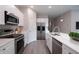 Modern kitchen featuring stainless steel appliances, white cabinets, and a stylish island at 170 Blaine St, Eustis, FL 32726