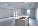 Bright open-concept kitchen with modern island, stainless steel faucet, and pendant lighting at 170 Blaine St, Eustis, FL 32726