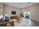 Cozy living room with modern decor, comfortable seating, and a large TV at 170 Blaine St, Eustis, FL 32726