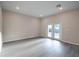 Bright, empty living room with modern floors and double doors to the outside at 170 Blaine St, Eustis, FL 32726