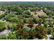 Aerial view of outlined property amidst lush greenery and neighboring homes in a tranquil suburban neighborhood at 1710 Alvarado Ct, Longwood, FL 32779