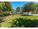 View of a large, grassy backyard with mature trees and a screened-in lanai area, perfect for outdoor relaxation at 1710 Alvarado Ct, Longwood, FL 32779
