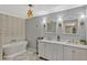 Luxurious bathroom with double vanity, a soaking tub, and stylish fixtures at 1710 Alvarado Ct, Longwood, FL 32779
