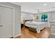 Well-lit bedroom with hardwood floors, ceiling fan, and a view to outside at 1710 Alvarado Ct, Longwood, FL 32779