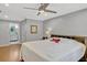 Bright bedroom with a ceiling fan, hardwood floors, and an adjacent bathroom at 1710 Alvarado Ct, Longwood, FL 32779