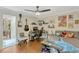 This cozy bedroom has laminate floors, a ceiling fan, and ample space for a workstation and collectibles at 1710 Alvarado Ct, Longwood, FL 32779