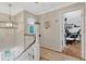 Upstairs hallway with a decorative chandelier and views of other rooms at 1710 Alvarado Ct, Longwood, FL 32779