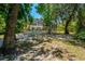 A large screened-in lanai, surrounded by trees, featuring an outdoor pool and patio furniture at 1710 Alvarado Ct, Longwood, FL 32779