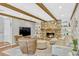 Comfortable living room with stone fireplace, hardwood floors, and wooden beams at 1710 Alvarado Ct, Longwood, FL 32779