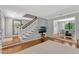 Inviting living room with staircase, hardwood floors, adjacent dining area, and a large mirror at 1710 Alvarado Ct, Longwood, FL 32779