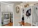 Mudroom featuring built-in storage, laundry facilities, and access to the garage and the rest of the home at 1710 Alvarado Ct, Longwood, FL 32779