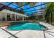 Gorgeous in-ground pool within a screened enclosure and a covered patio, perfect for relaxation and entertainment at 1710 Alvarado Ct, Longwood, FL 32779