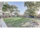 Expansive backyard with a patio seating area, shed, trampoline, and beautifully manicured lawn at 1905 Lady Ave, Ocoee, FL 34761