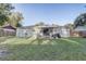 Large backyard featuring an outdoor patio area and mature landscaping, perfect for relaxation at 1905 Lady Ave, Ocoee, FL 34761