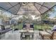 Well-maintained backyard featuring an outdoor seating area, lush lawn, and mature landscaping at 1905 Lady Ave, Ocoee, FL 34761