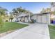 Lovely home featuring a well-maintained lawn, spacious driveway, and charming front porch at 1905 Lady Ave, Ocoee, FL 34761