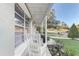 Relaxing front porch featuring a comfortable rocking chair and views of the manicured lawn at 1905 Lady Ave, Ocoee, FL 34761
