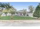 Inviting home with a lush green lawn, beautiful palm trees, and charming curb appeal at 1905 Lady Ave, Ocoee, FL 34761