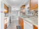 Charming kitchen featuring wood cabinets, granite countertops, and hardwood floors at 1905 Lady Ave, Ocoee, FL 34761