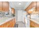 Charming kitchen featuring wood cabinets, granite countertops, and hardwood floors at 1905 Lady Ave, Ocoee, FL 34761