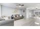 Inviting living room features hardwood floors, neutral paint, ceiling fan and a view to the dining area at 1905 Lady Ave, Ocoee, FL 34761