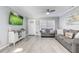 Bright living room featuring sleek vinyl flooring, a modern ceiling fan, and lots of natural light at 1905 Lady Ave, Ocoee, FL 34761