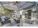 Covered patio boasts comfortable seating, a ceiling fan, and a mounted television for outdoor enjoyment at 1905 Lady Ave, Ocoee, FL 34761