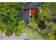 Home with unique landscaping featuring bright red mulch and mature trees at 207 Sweet Gum Way, Longwood, FL 32779