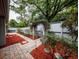 Landscaped backyard garden with stone pathway and mature trees at 207 Sweet Gum Way, Longwood, FL 32779