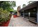 Backyard brick patio with stone fireplace and modern architectural details at 207 Sweet Gum Way, Longwood, FL 32779