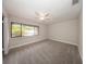 This bedroom features neutral paint and carpet plus a ceiling fan and a large window at 207 Sweet Gum Way, Longwood, FL 32779