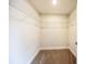 Walk-in closet with carpeted floor and wall-mounted shelving at 207 Sweet Gum Way, Longwood, FL 32779