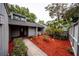 A welcoming facade is complete with bright red mulch and a decorative glass front door at 207 Sweet Gum Way, Longwood, FL 32779