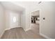 Bright foyer featuring modern vinyl flooring, a closet, and a view into the kitchen at 207 Sweet Gum Way, Longwood, FL 32779