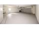 Spacious garage with neutral walls, epoxy flooring, and an electric garage door at 207 Sweet Gum Way, Longwood, FL 32779