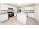 Updated kitchen with white cabinetry, granite countertops, stainless steel appliances, and central island at 207 Sweet Gum Way, Longwood, FL 32779