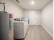 A laundry room featuring a washer and dryer, water heater, and wood look flooring at 207 Sweet Gum Way, Longwood, FL 32779