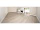 Spacious living room with modern wood-look flooring, lots of natural light, and vaulted ceiling at 207 Sweet Gum Way, Longwood, FL 32779
