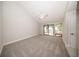 Spacious main bedroom featuring plush carpeting, vaulted ceilings and a sliding door to the garden at 207 Sweet Gum Way, Longwood, FL 32779