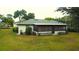 Back exterior view of the house with a screened in porch and green backyard at 2100 Shirewood Ct, Winter Park, FL 32792