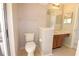 Cozy bathroom featuring a single vanity, mirror and neutral tiling at 2100 Shirewood Ct, Winter Park, FL 32792