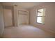 Neutral bedroom featuring a closet, carpet and window with peaceful backyard view at 2100 Shirewood Ct, Winter Park, FL 32792