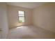 Neutral bedroom with a window providing natural light, carpeted flooring, and neutral walls at 2100 Shirewood Ct, Winter Park, FL 32792