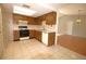 Functional kitchen with wood cabinets, a range, white appliances, and tile flooring at 2100 Shirewood Ct, Winter Park, FL 32792