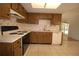Functional kitchen with wood cabinets, white countertops and tile flooring at 2100 Shirewood Ct, Winter Park, FL 32792