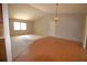 Bright living room featuring carpet and hardwood flooring, window views and a high ceiling at 2100 Shirewood Ct, Winter Park, FL 32792