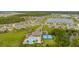 Aerial view of a neighborhood featuring a community pool, tennis courts, and picturesque homes with lush landscaping at 2907 Sime St, New Smyrna Beach, FL 32168