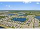 Expansive aerial view showcasing a community with multiple homes surrounding several scenic lakes at 2907 Sime St, New Smyrna Beach, FL 32168