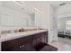 Spacious bathroom featuring a dual sink vanity and a view into the adjoining bedroom at 2907 Sime St, New Smyrna Beach, FL 32168