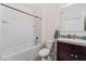 Bright bathroom with a white bathtub, shower, toilet, sink, vanity and mirror at 2907 Sime St, New Smyrna Beach, FL 32168